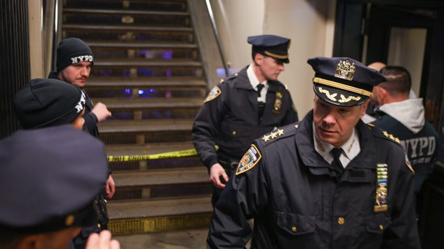 New York Police walk through the Mount Eden subway station while investigating a shooting on the platform, Monday, Feb. 12, 2024, in the Bronx borough of New York. (NYPD Chief of Department via X)