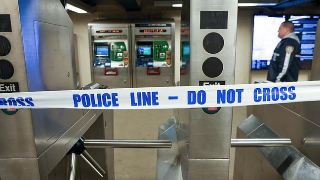 New York Police walk through the Mount Eden subway station while investigating a shooting, Monday, Feb. 12, 2024, in the Bronx borough of New York. Several people were shot Monday at the New York City subway station, police said. (New York Police Department via AP)