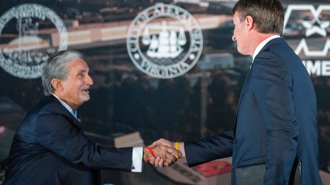 FILE - Ted Leonsis, left, owner of the Washington Wizards NBA basketball team and the Washington Capitals NHL hockey team, shakes hands with Virginia Gov. Glenn Youngkin as they announce plans for a new sports stadium for the teams, Dec. 13, 2023, in Alexandria, Va. Legislation underpinning a plan to relocate the Wizards and the Capitals across the Potomac River to northern Virginia easily cleared an early hurdle in the state Legislature, Friday, Feb. 9, 2024. (AP Photo/Alex Brandon, File)